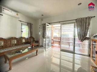 Bright living room with traditional wooden furniture and large sliding glass doors