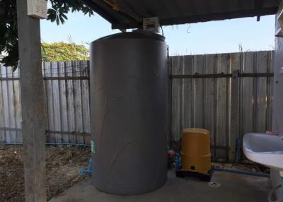 Water tank and water pump in a covered utility area