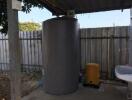 Water tank and water pump in a covered utility area