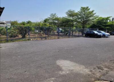 Parking area with cars and surrounding greenery