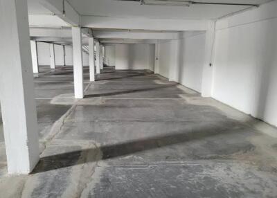 Empty commercial or parking space with concrete floors and columns