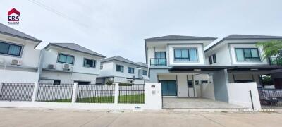 Modern two-story residential buildings with fenced yards