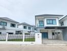 Modern two-story residential buildings with fenced yards