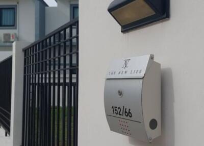 Exterior view of a modern house with fence and mailbox