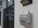 Exterior view of a modern house with fence and mailbox