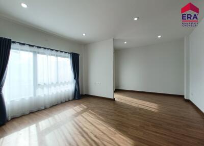 Spacious living room with wooden floors and large windows