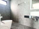 Modern bathroom with tiled walls and floor