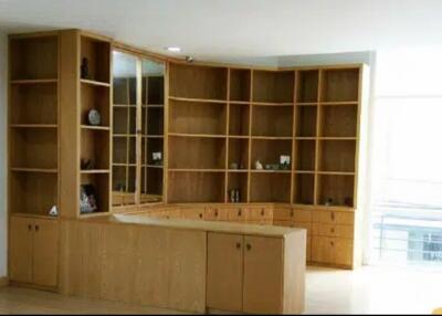 Living room with wooden built-in shelves and cabinets