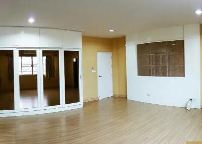 Living room with wooden flooring and large windows