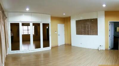 Living room with wooden flooring and large windows