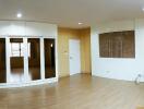 Living room with wooden flooring and large windows