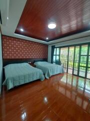 Spacious bedroom with two beds and large windows