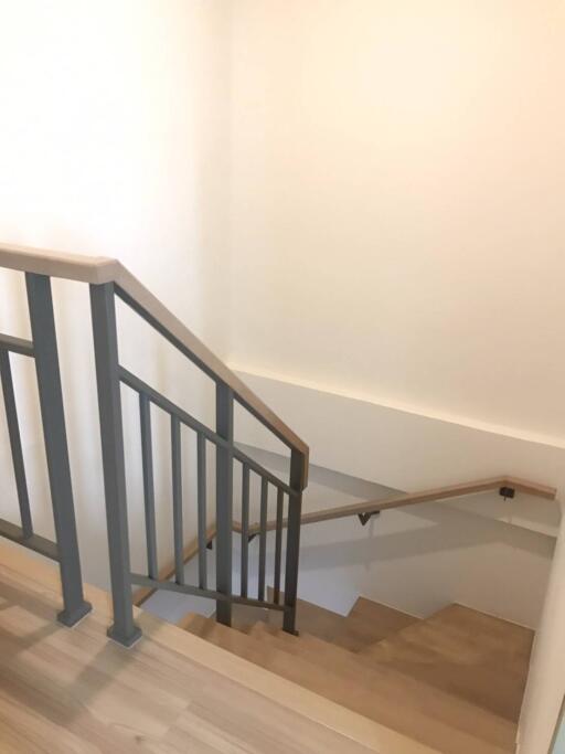 View of a staircase with wooden steps and metal railings