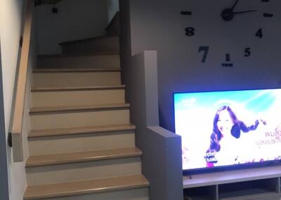Living area with staircase and TV