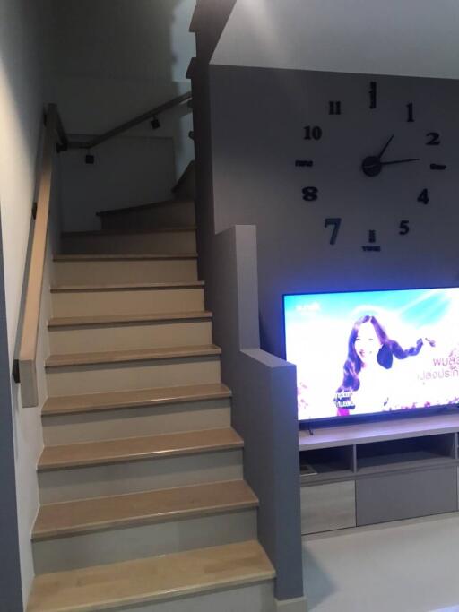 Living area with staircase and TV