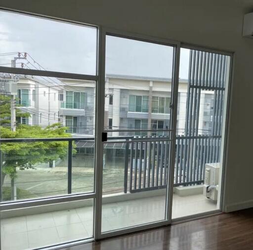 Living room with large glass sliding doors and balcony