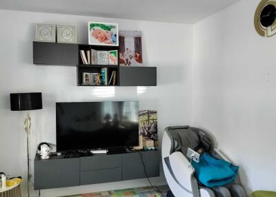 Modern living room with entertainment center and massage chair