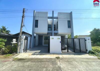 Modern front view of a house with a driveway and gate