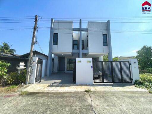 Modern front view of a house with a driveway and gate