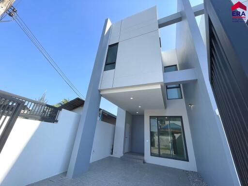 Modern multi-story building with large glass windows and minimalistic design