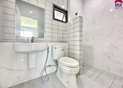 Modern bathroom with sink, toilet, and shower area