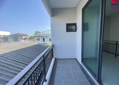 Balcony with railing and view of neighboring buildings