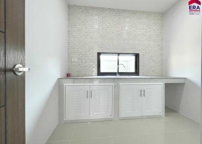 Modern kitchen with tiled backsplash and cabinetry