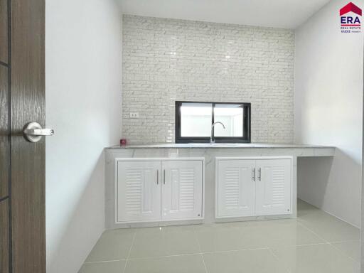 Modern kitchen with tiled backsplash and cabinetry
