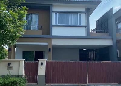 Front view of a two-story house with a gated entrance