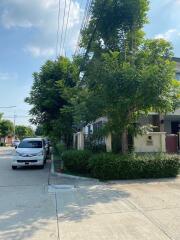 Exterior view of building with trees and parked cars