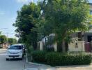 Exterior view of building with trees and parked cars