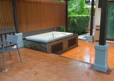 outdoor patio with hot tub and seating area