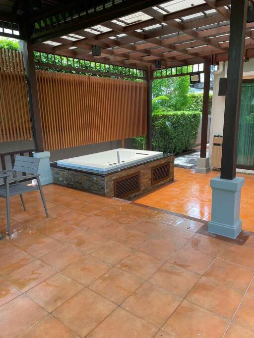 outdoor patio with hot tub and seating area