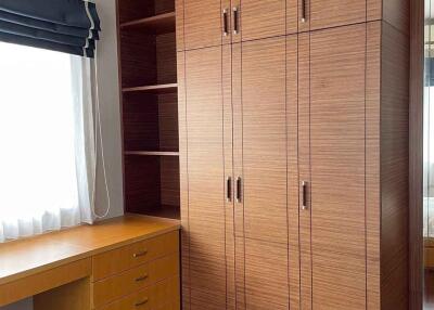 Bedroom with wooden wardrobe and desk