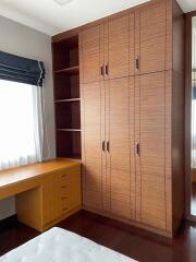 Bedroom with wooden wardrobe and desk