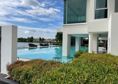 Modern building with outdoor pool and waterfront view