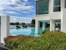 Modern building with outdoor pool and waterfront view