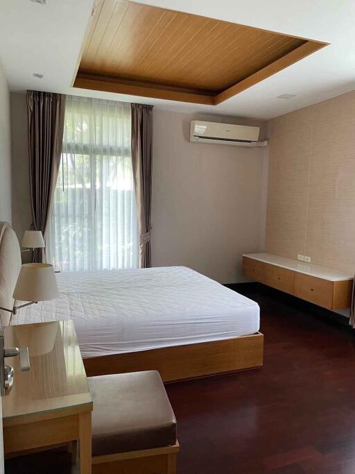 Spacious bedroom with a large window, recessed lighting, and air conditioning