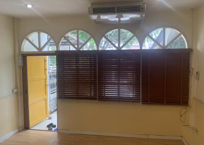 Living room with large windows and wooden blinds