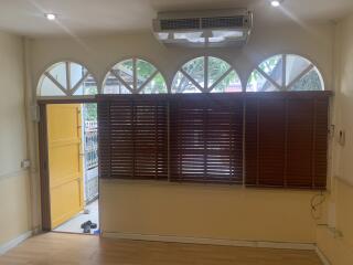 Living room with large windows and wooden blinds