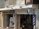 Street view of a commercial building with a barber shop