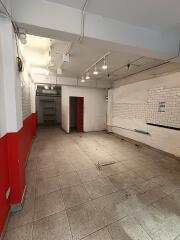 Empty room with tiled floor and red and white painted walls
