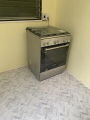 Kitchen with stove and tiled floor