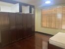 Bedroom with wooden wardrobe and large window