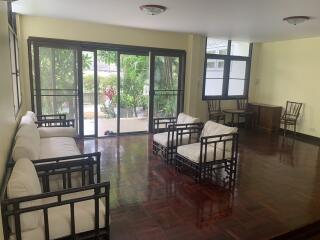 Spacious living room with large windows and garden view