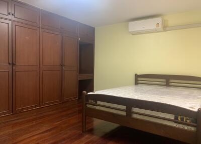 Bedroom with wooden furniture and flooring