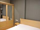 bedroom with wooden wardrobe and bed
