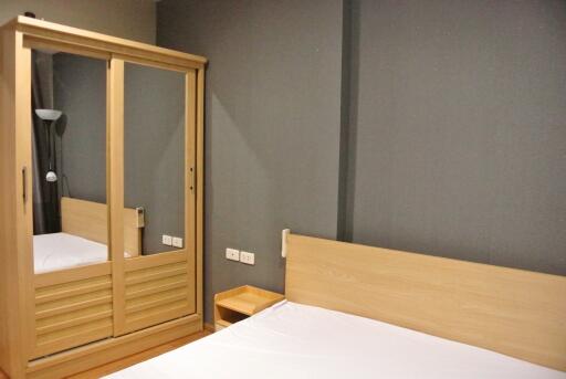 bedroom with wooden wardrobe and bed