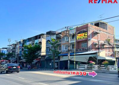 Street view of commercial buildings with RE/MAX signage