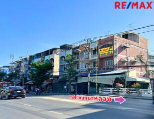 Street view of commercial buildings with RE/MAX signage